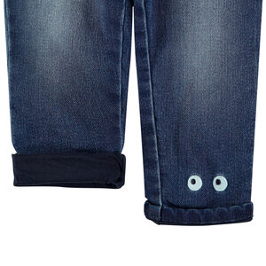 Jean effet used doublé jersey à yeux brodés 