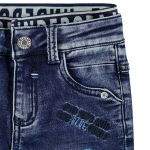 Jeans effet used et crinkle avec double taille élastiquée et broderies 