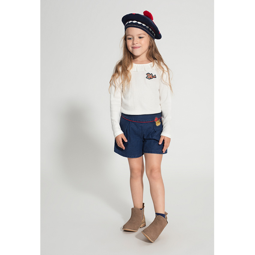 Short en faux-uni avec badge à franges et touches de rouge 