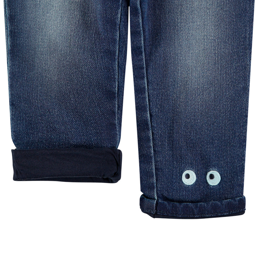 Jean effet used doublé jersey à yeux brodés 