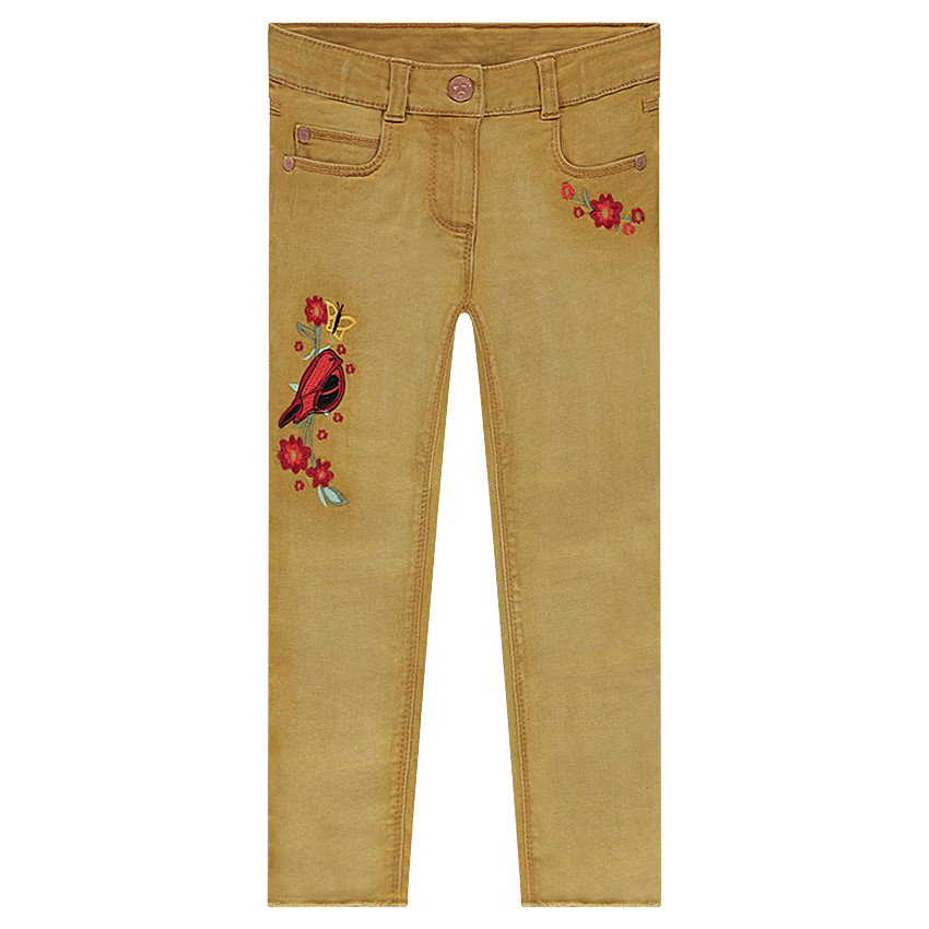 Jeans effet used avec oiseau et fleurs brodés sur les jambes  