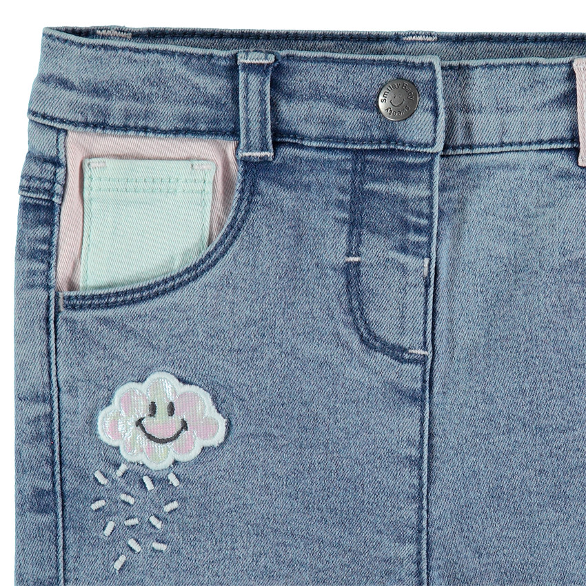 Jean slim effet used à badges Smiley 