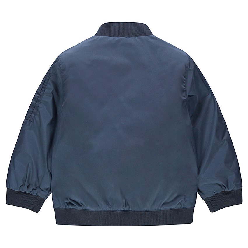 Junior - Teddy bleu uni avec doublure imprimée et poche zippée 