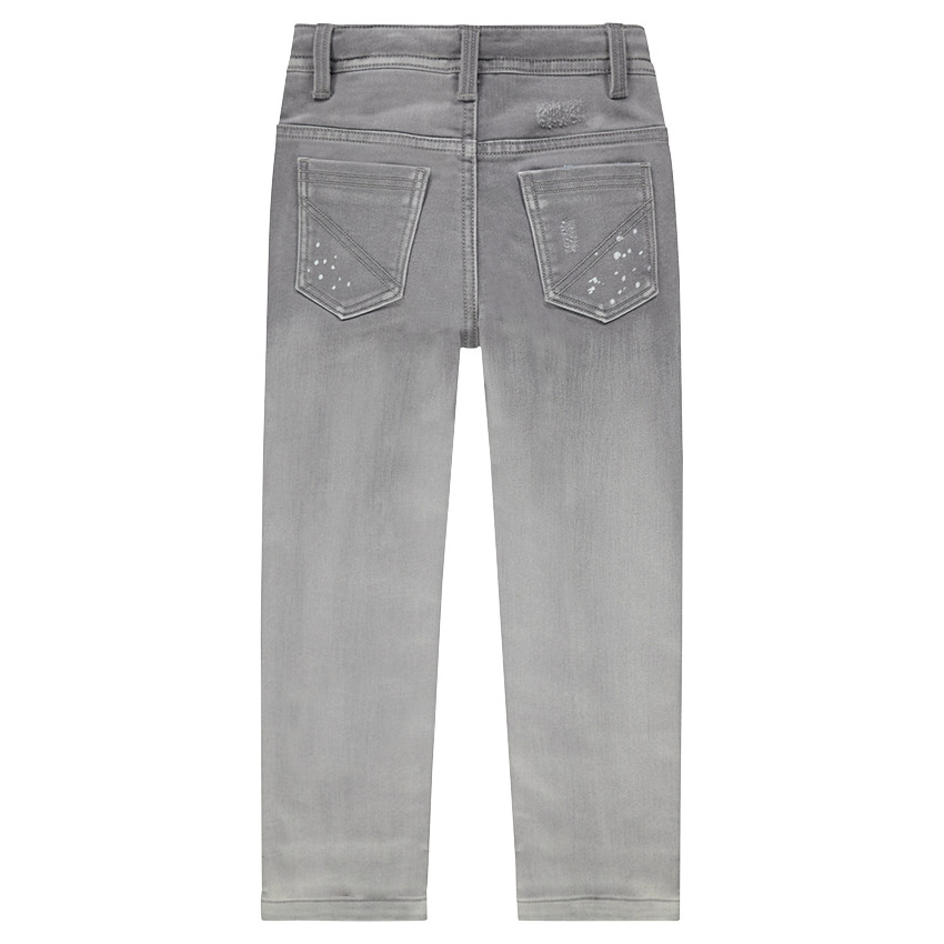 Jeans effet used avec taches printées et badges patchés 