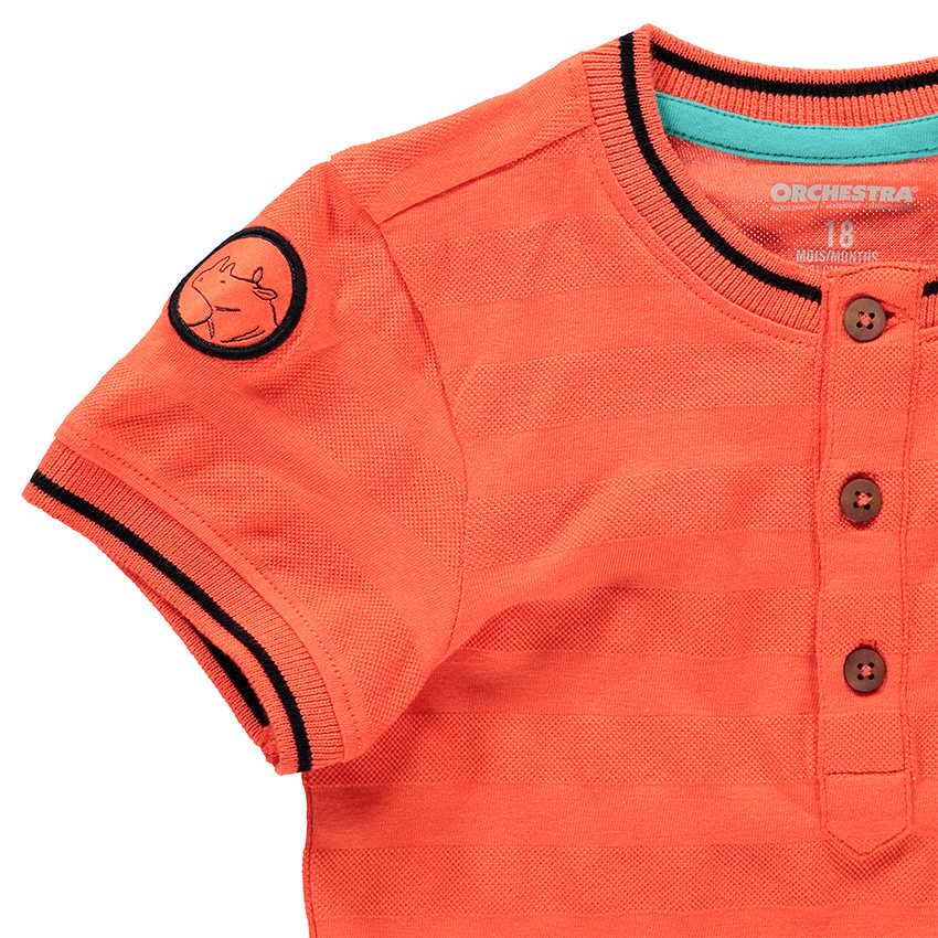 Polo manches courtes en coton orange avec poche et girafe printée 