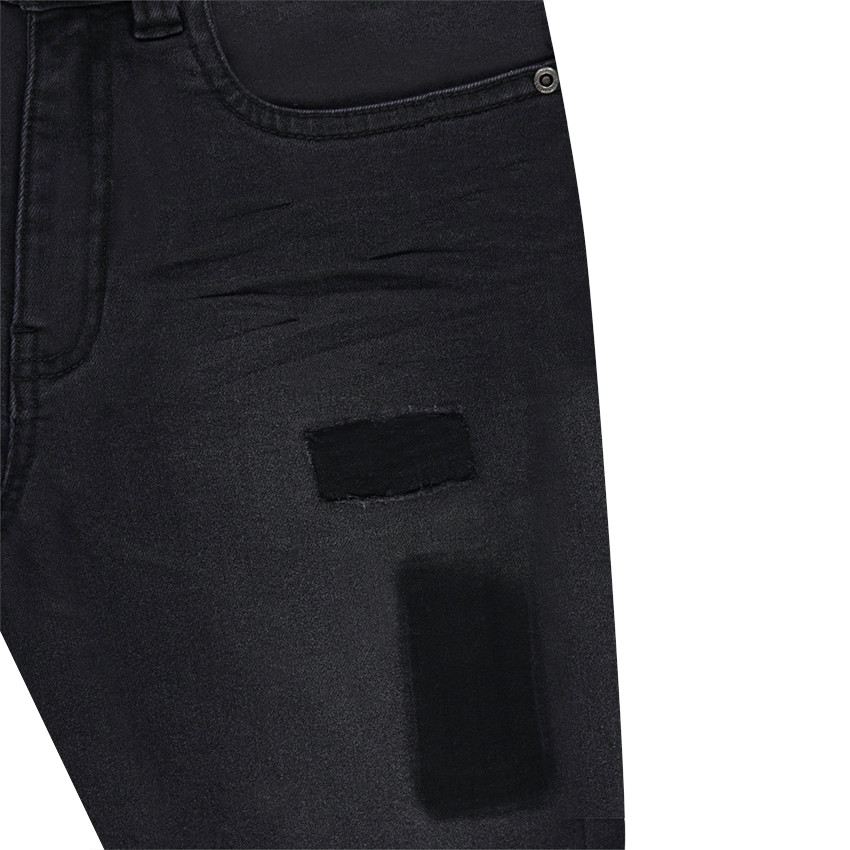 Jeans effet used et crinkle avec ombres de patchs 